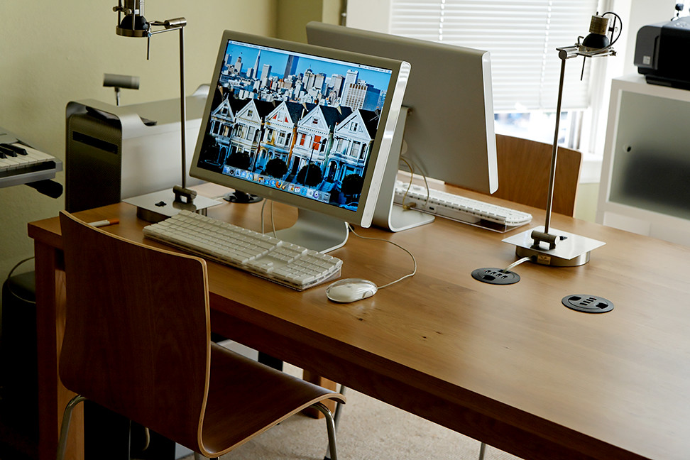A desk with a laptop and notes